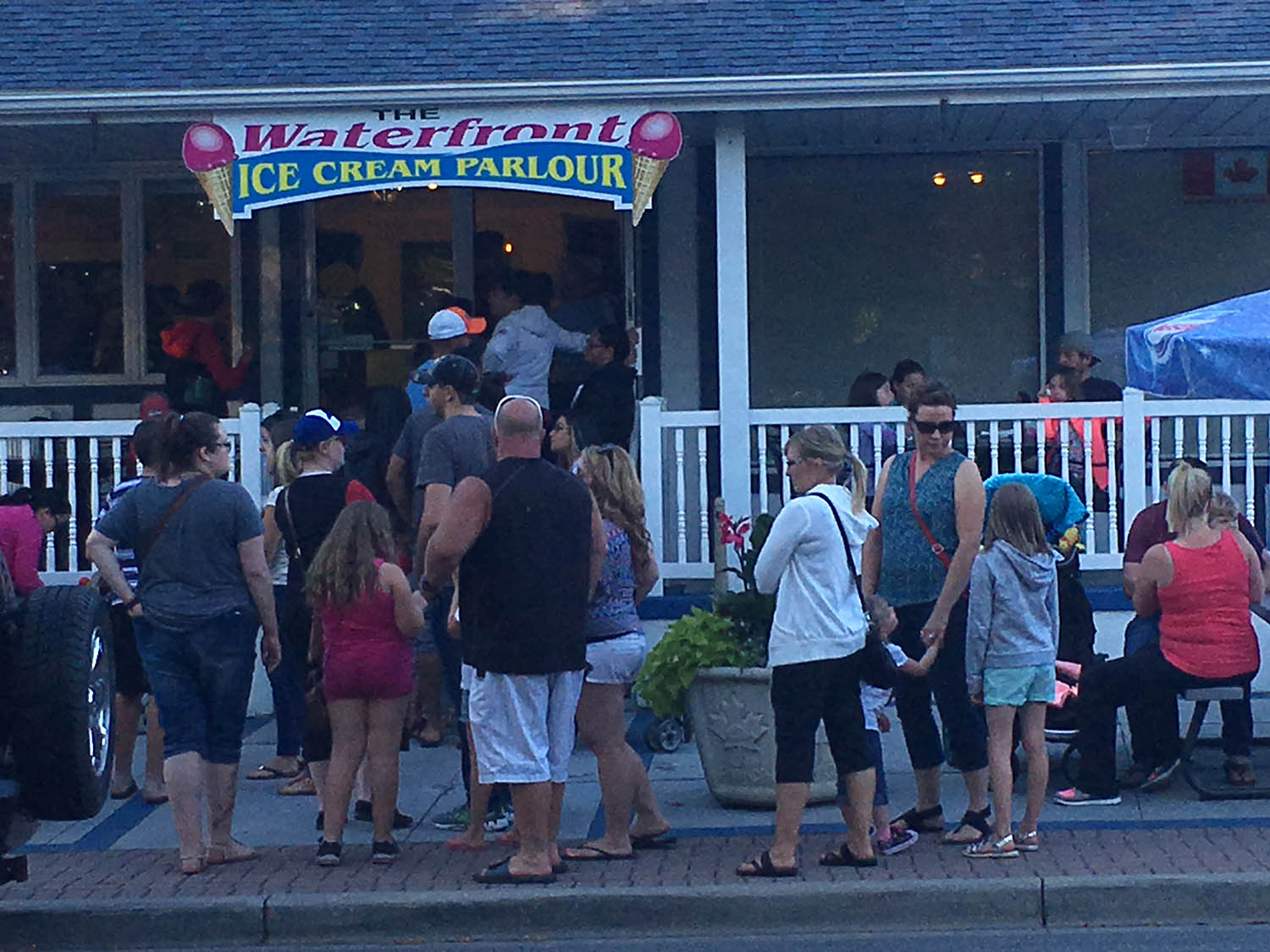 A group of people standing outside of a store.