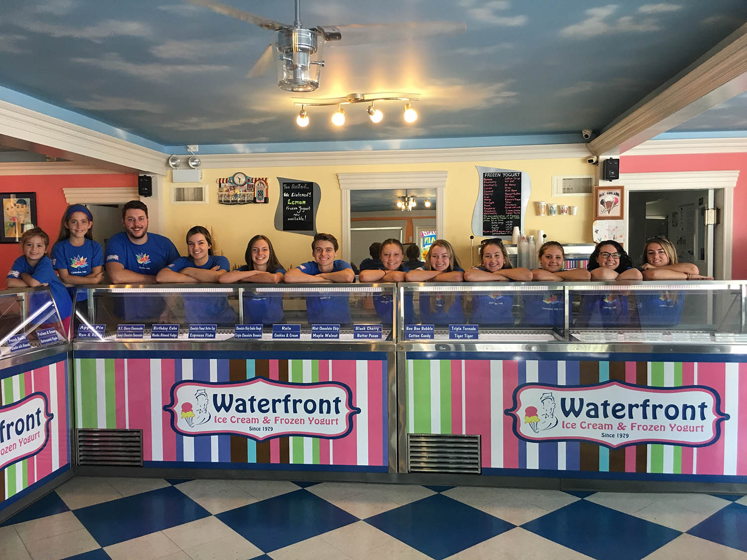 A group of people standing in front of a counter.