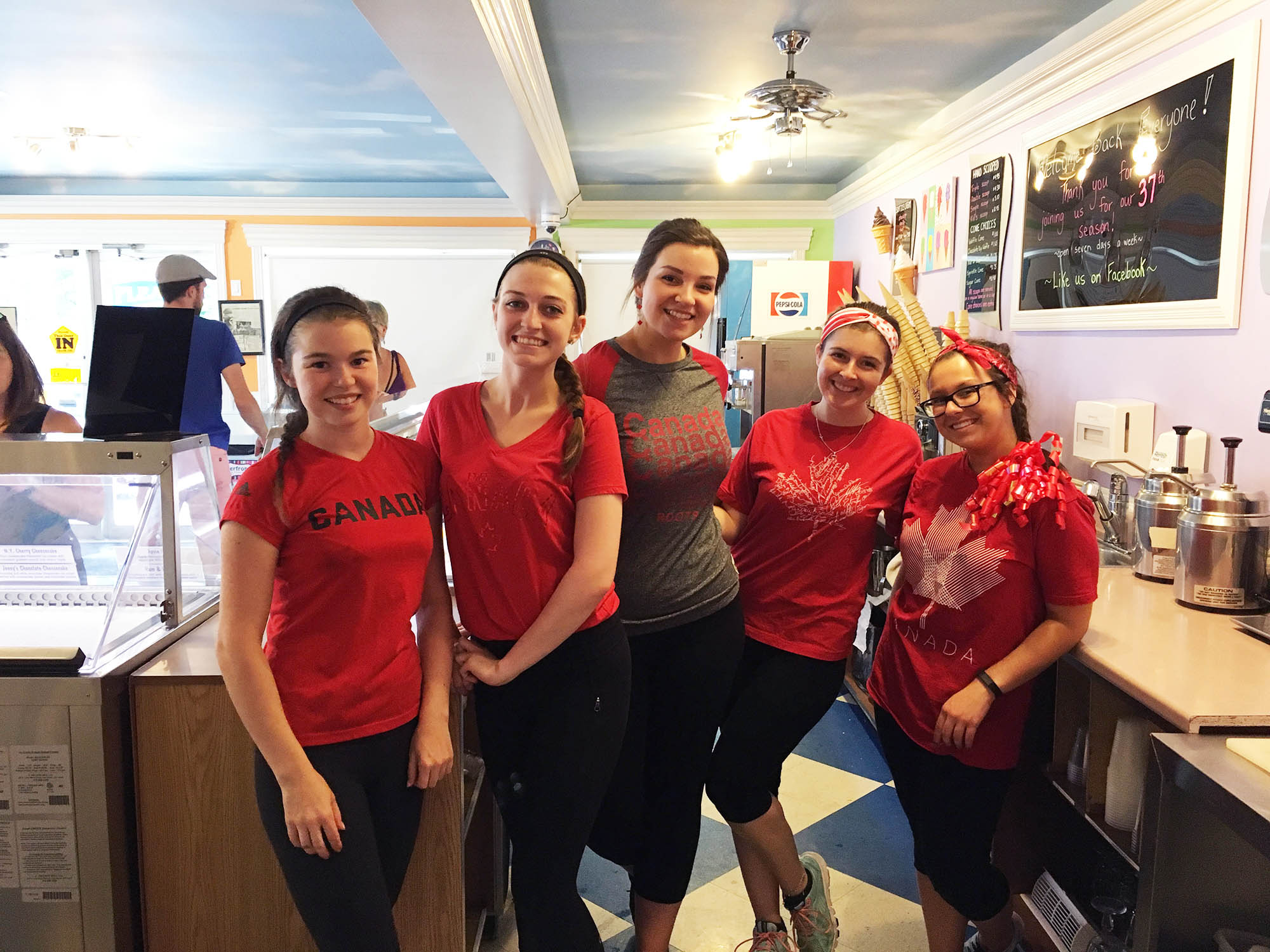 A group of women standing in front of a counter.