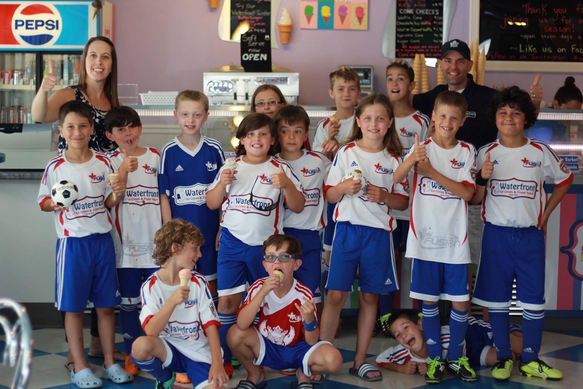 A group of young soccer players posing for a picture.