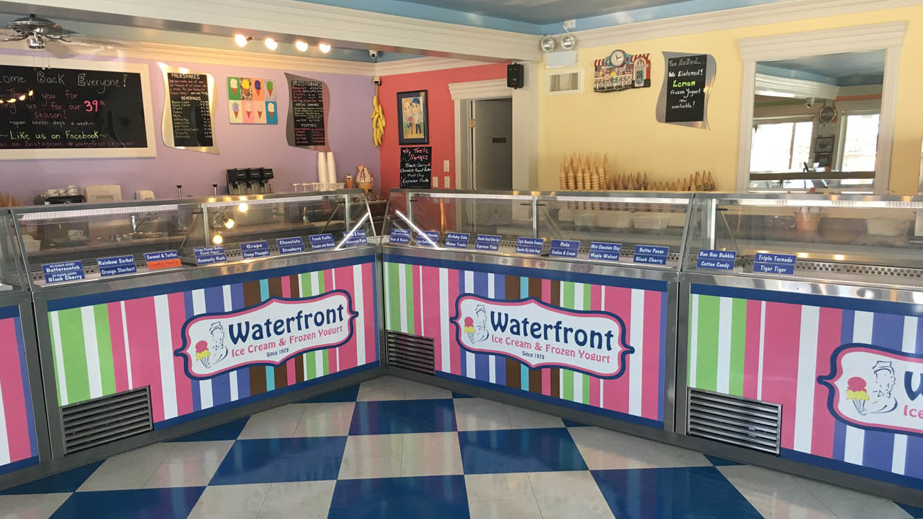 A colorful ice cream shop with a checkered floor.