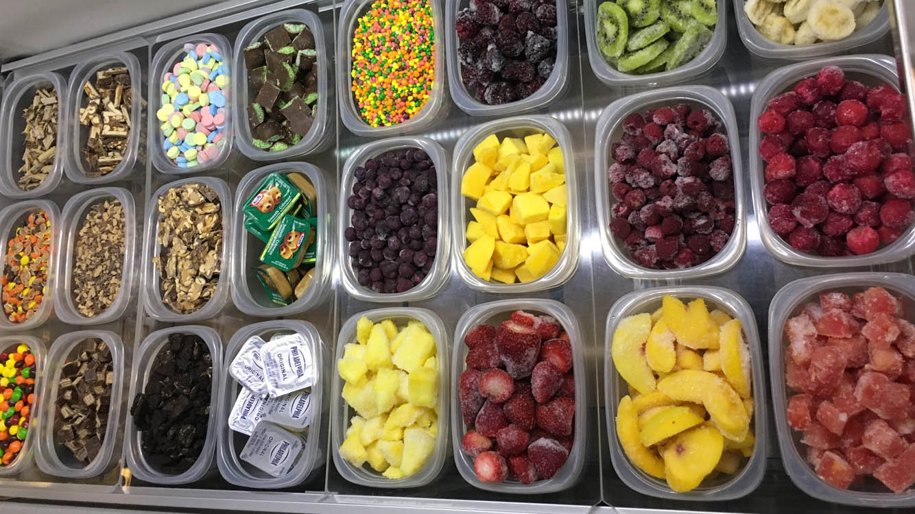 A tray of different types of fruit and candies.