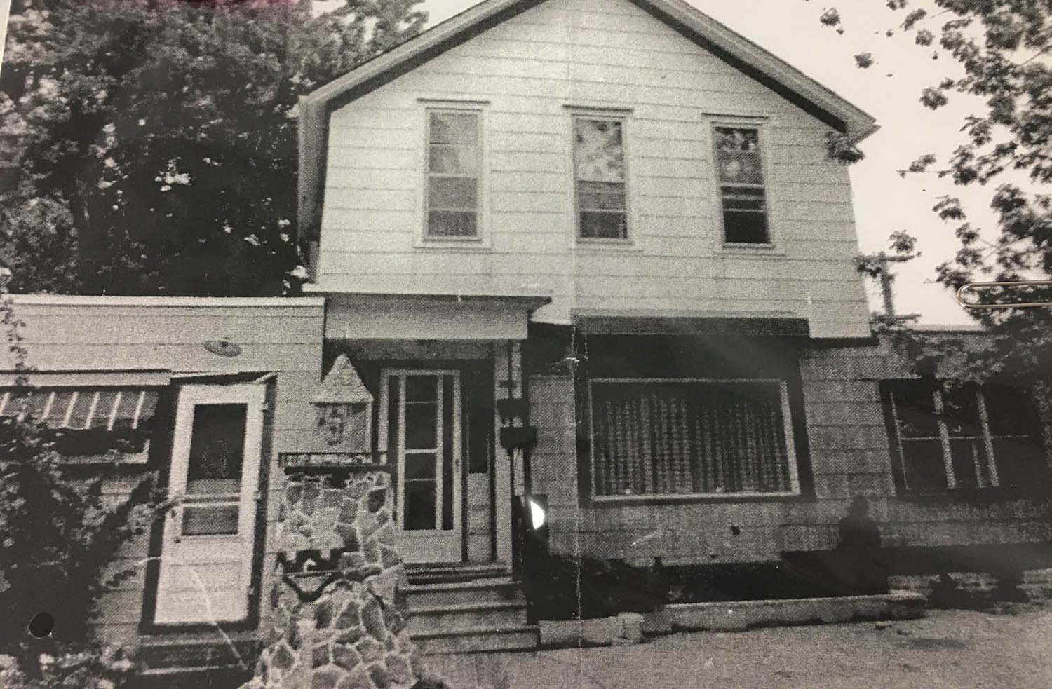 A black and white photo of an old house.